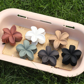 Sisiaipu Flower Claw Clip in Dark Brown with flowers in background