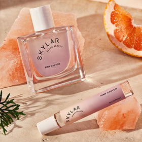 Skylar Pink Canyon Rollerball on a desk with flowers