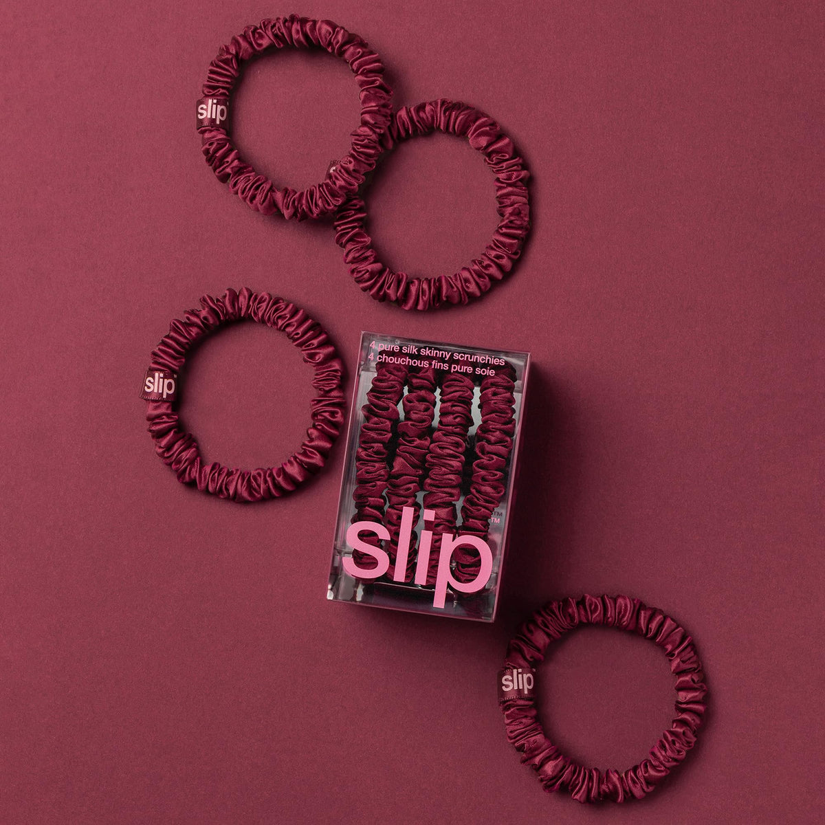 SLIP maroon silk skinny scrunchies set of 4 on a table