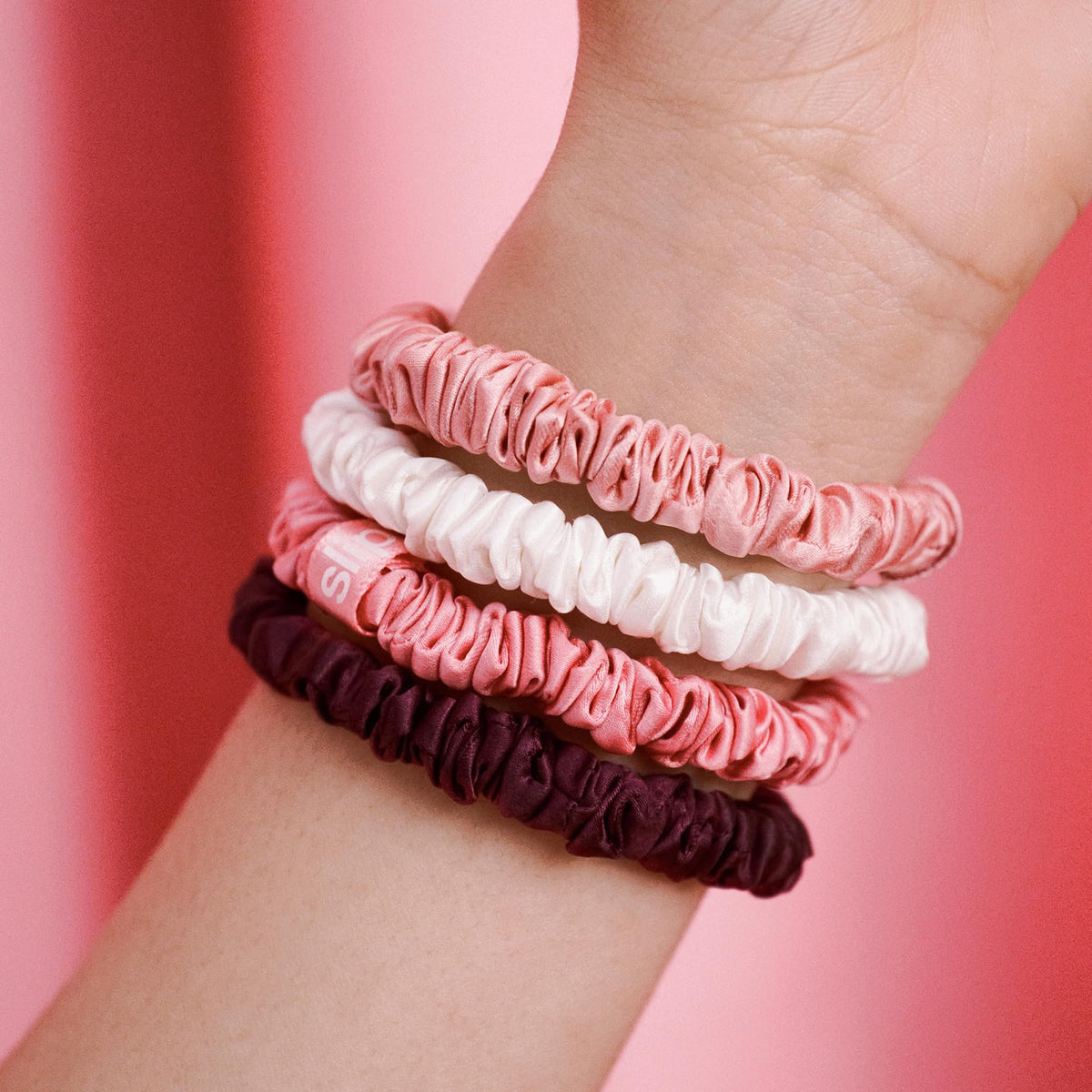 SLIP scrunchies in Blush, Harriet, and White colours
