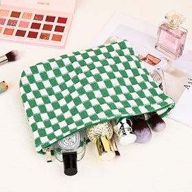 SOIDRAM checkered makeup bag on a travel suitcase