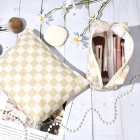 SOIDRAM Checkered Makeup Bag set in a travel setting