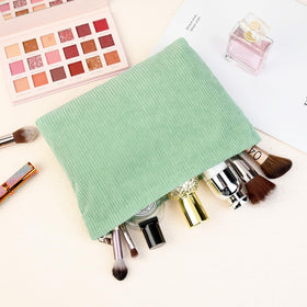SOIDRAM cosmetic bag lifestyle scene on a suitcase