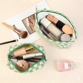 SOIDRAM makeup bags arranged on a vanity with cosmetics