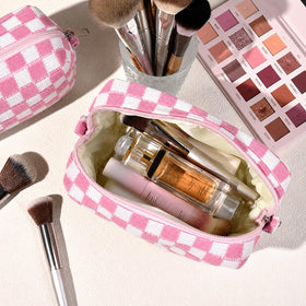 SOIDRAM pink checkered cosmetic bags stacked together