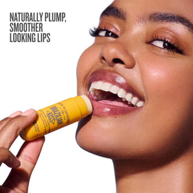 Sol de Janeiro Brazilian Kiss Vegan Lip Butter Balm on a wooden surface