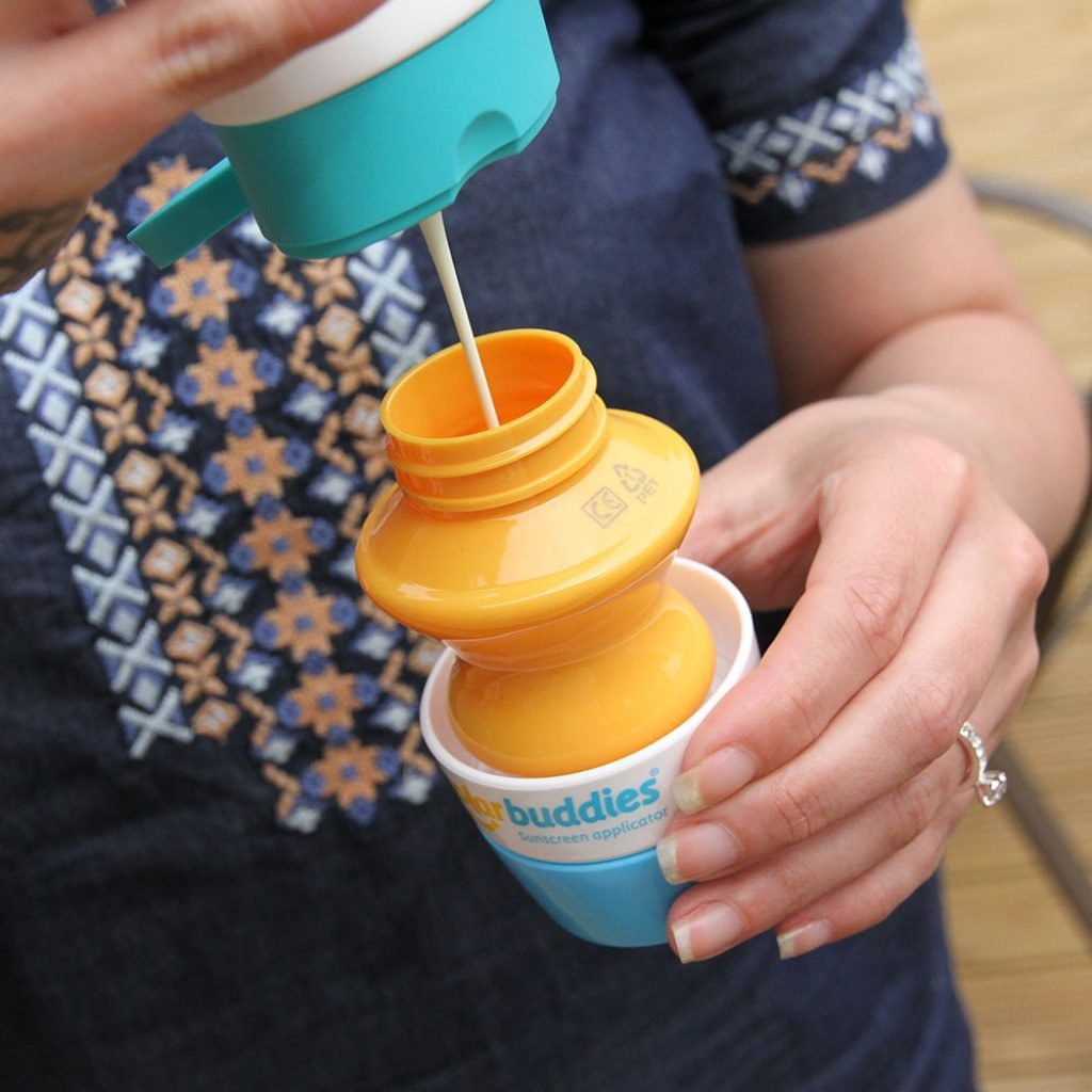 Solar Buddies applicator filled with sunscreen on a beach