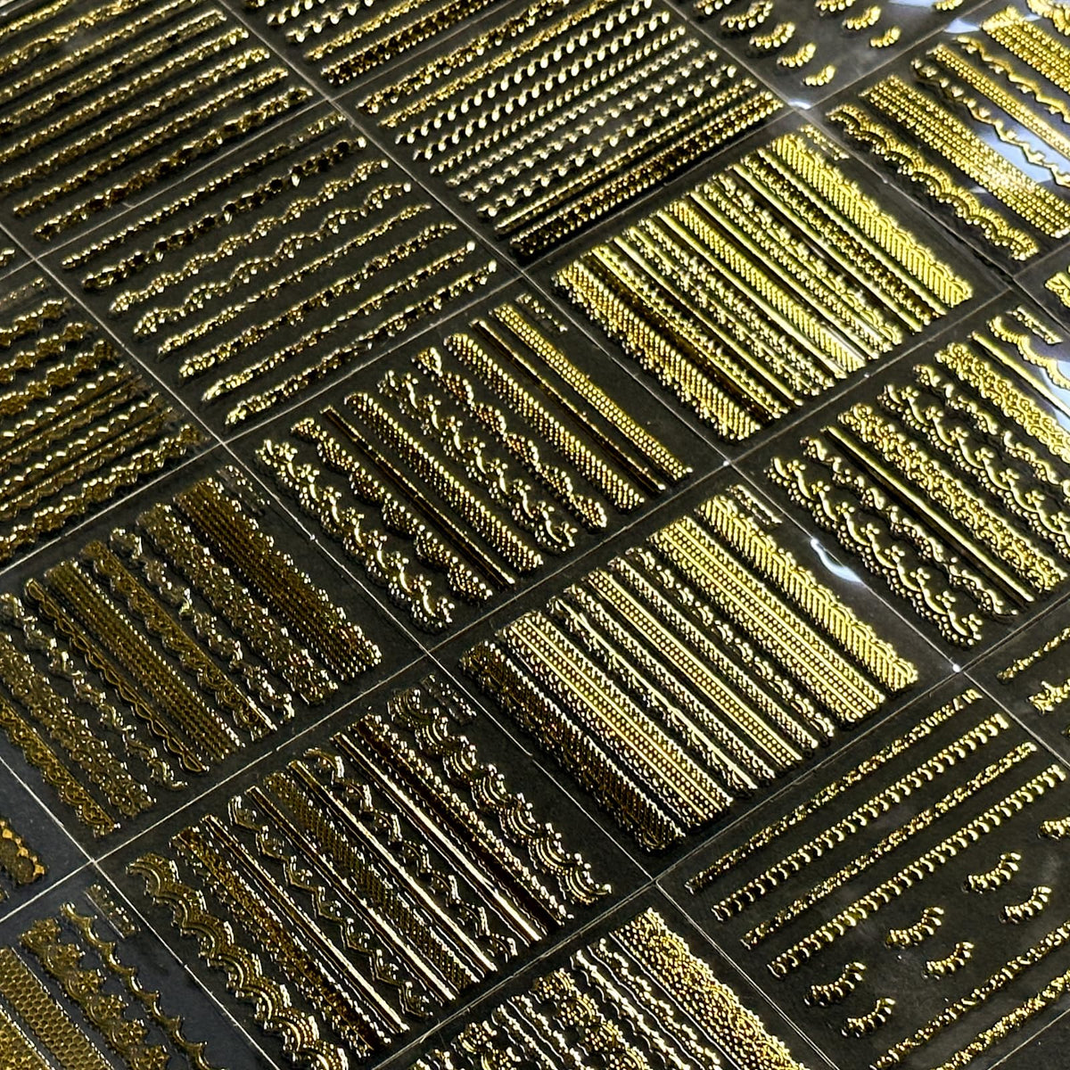 SPLOCUDU gold nail stickers applied on acrylic nails
