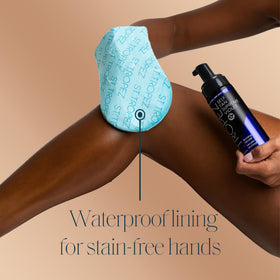 St.Tropez mitt with packaging on a flat surface