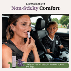 StinkBalm Lavender balm beside travel essentials