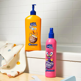 Suave Kids Detangler Spray 10 oz with a child brushing their hair