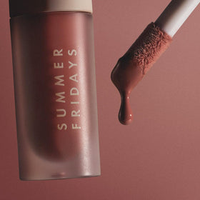 Summer Fridays Dream Lip Oil with floral background
