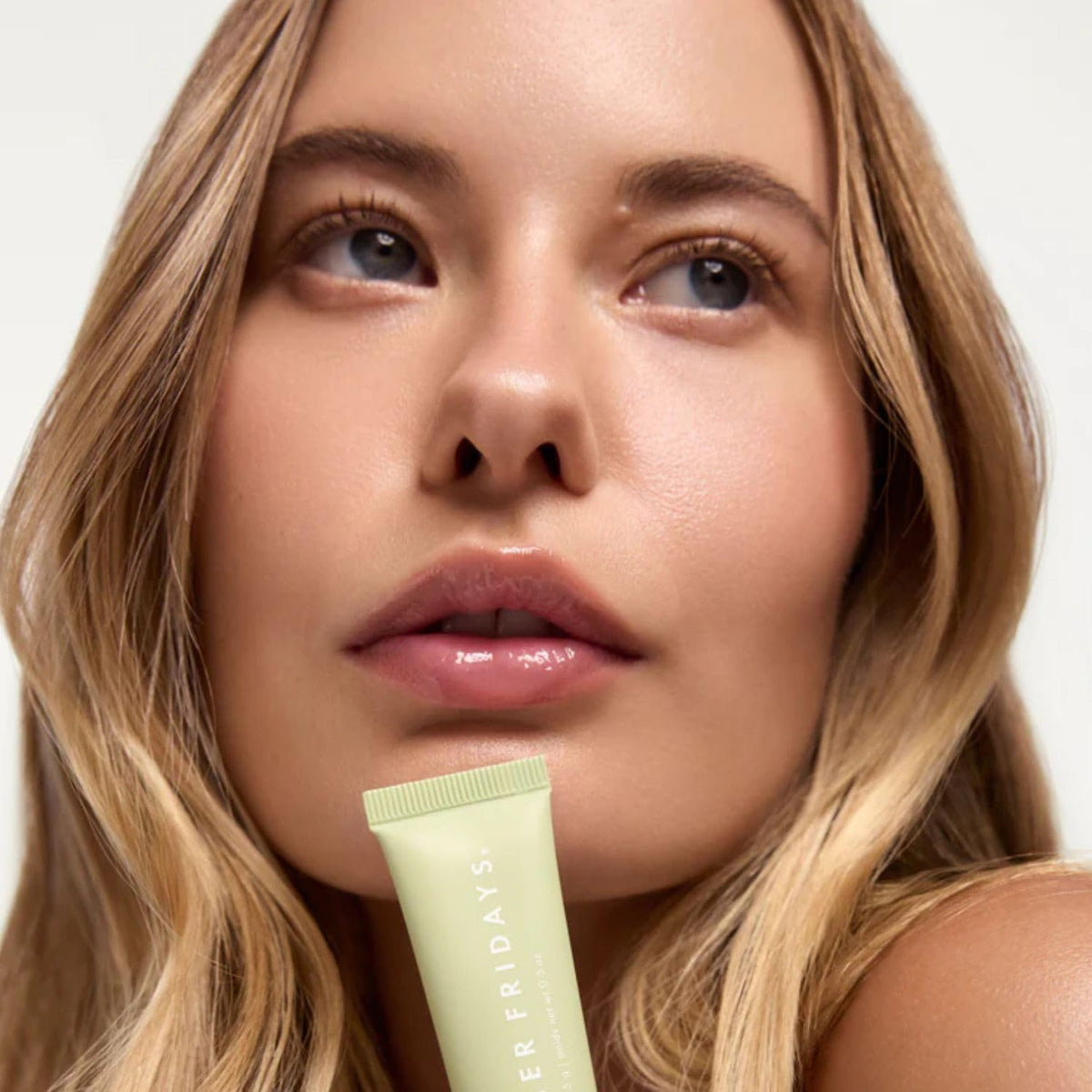 Summer Fridays Lip Butter Balm on a table with other beauty products