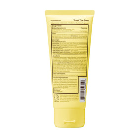 Sun Bum Kids SPF 50 Clear Sunscreen Lotion on a beach towel with sunscreen accessories