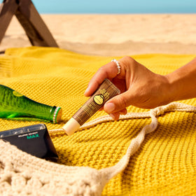 Sun Bum SPF 30 Coconut Lip Balm in hand
