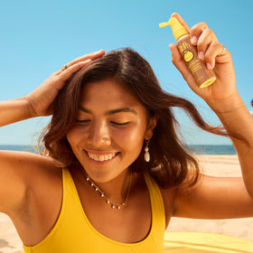 Sun Bum SPF 30 Scalp and Hair Mist Spray on a sunny beach