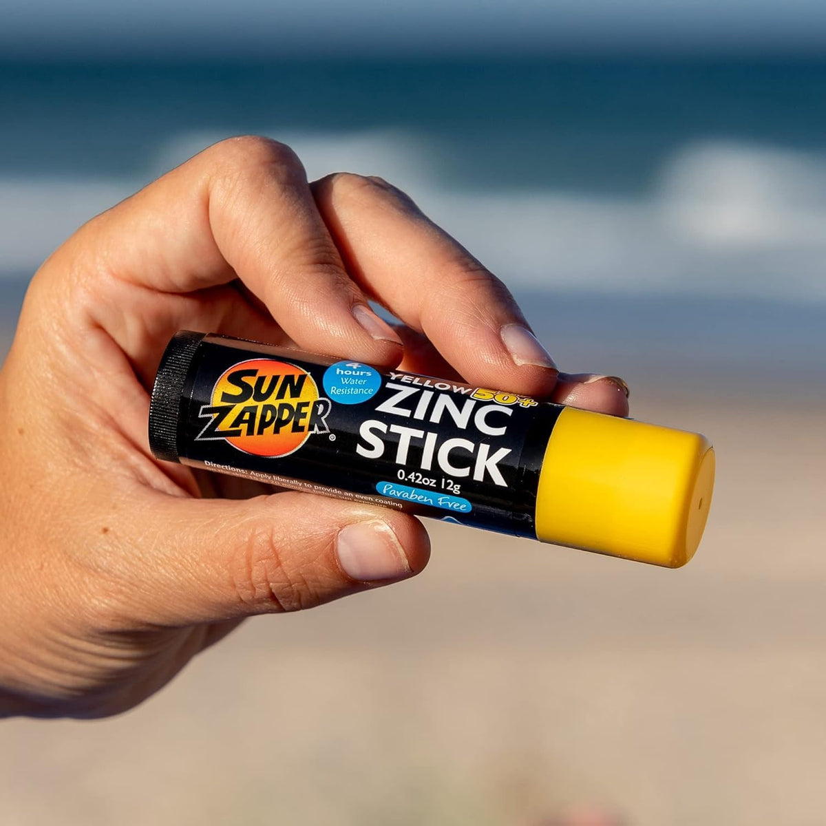 Sun Zapper Zinc Oxide Sunscreen Stick on a beach bag