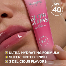 Supergoop! Glow Gloss Lip Balm on a wooden surface