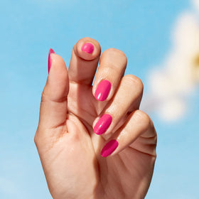 Swatch of OPI Nature Strong bright pink nail polish on nails