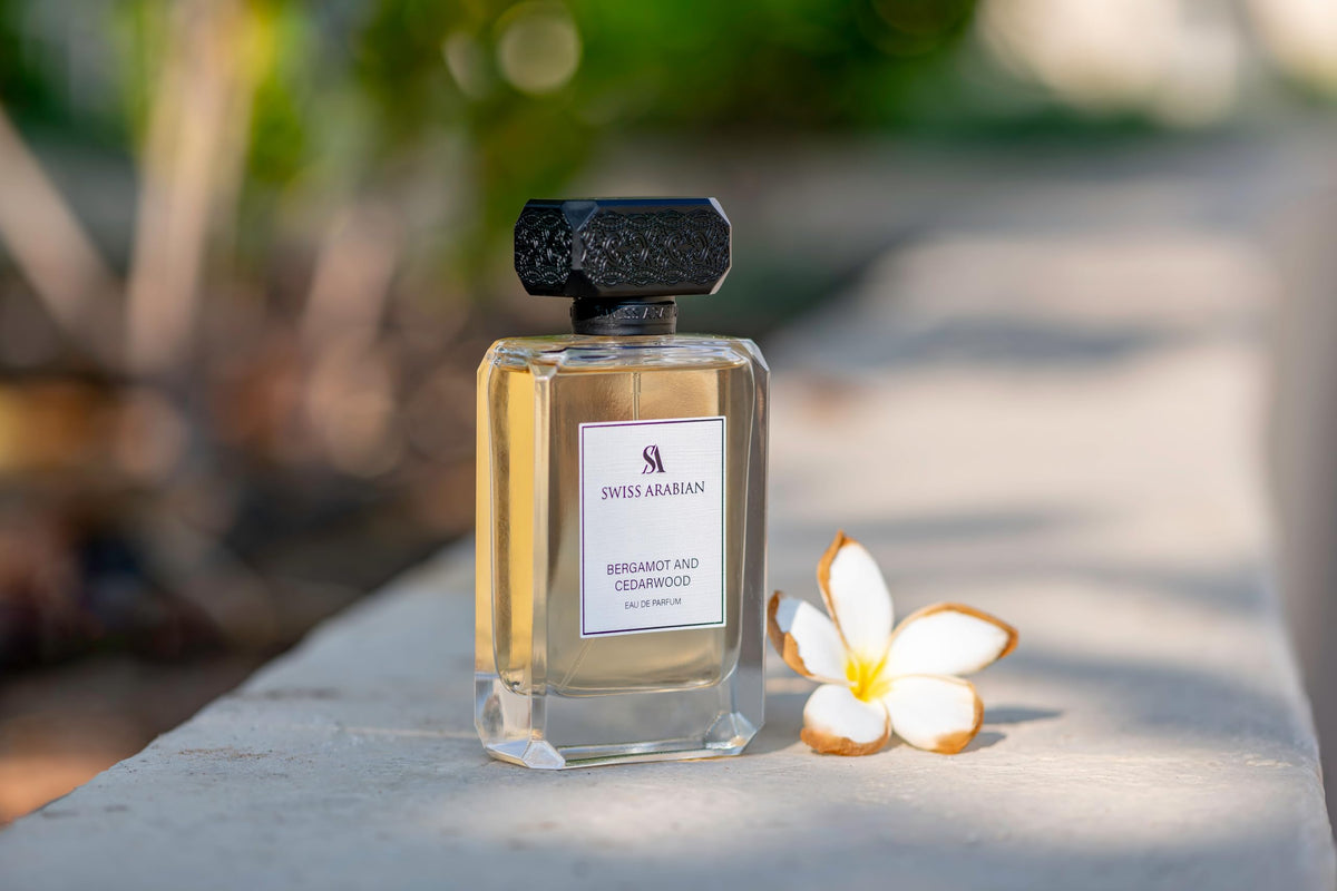 Swiss Arabian Bergamot and Cedarwood perfume on a wooden table