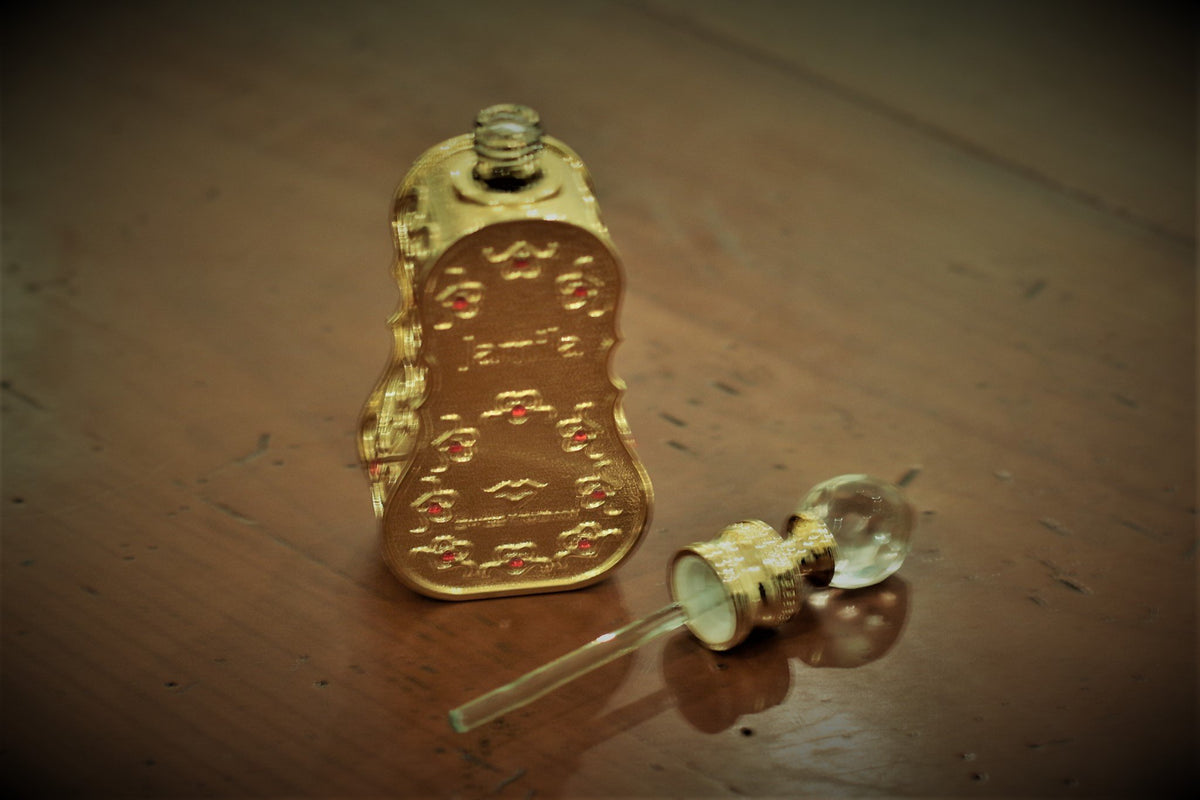 Swiss Arabian Jamila perfume oil packaging with floral background