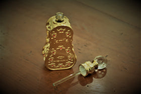 Swiss Arabian Jamila perfume oil packaging with floral background