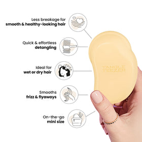 TANGLE TEEZER Mini Detangler Hair Brush held in a child's hand