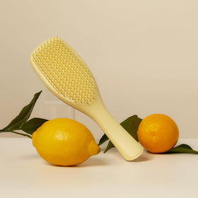TANGLE TEEZER Plant-Based Ultimate Detangler Curly Hair Brush in use on curly hair