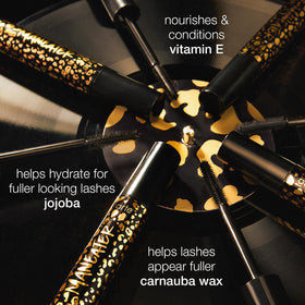 tarte Maneater Mascara on a vanity with beauty products