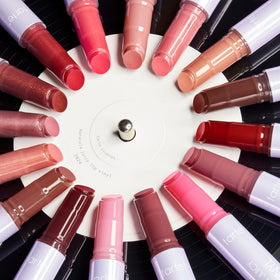 tarte Maracuja Juicy Lip Vinyl Gloss with makeup accessories