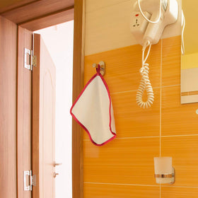 Tatuo exfoliating wash cloths displayed on a towel rack
