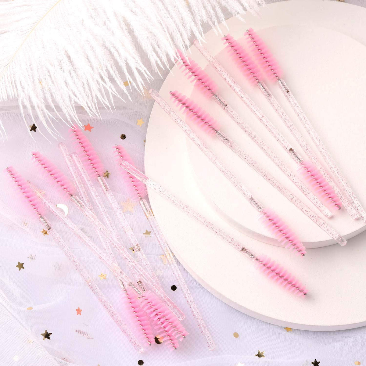 Tbestmax pink eyelash brush wands on a makeup table