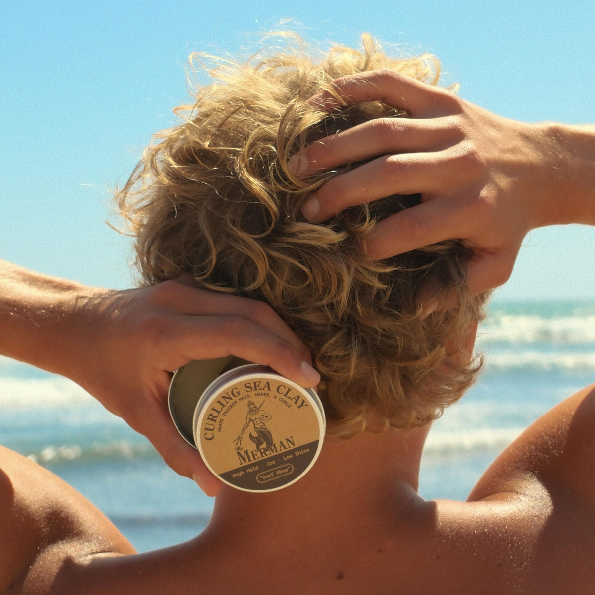 The Merman Curling Sea Clay with a coastal background