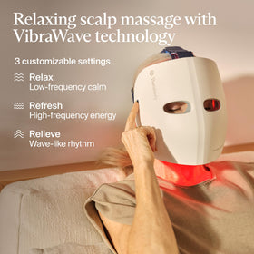 TheraFace Glo LED face mask with user enjoying scalp massage