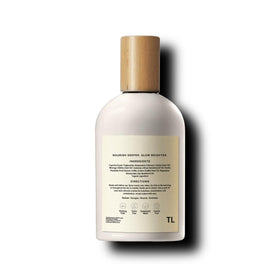 Third Layer Day Spray Body Oil on a wooden surface