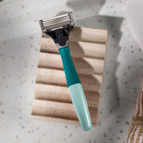 Three Harry's razor blade refills displayed next to the handle
