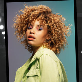 TIGI Curls Rock Amplifier Shaping Cream in a bathroom setting