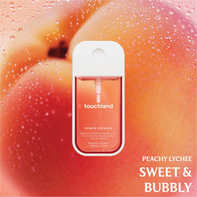 Touchland Fruity Crush Hand Sanitizer and Mist set on a travel bag