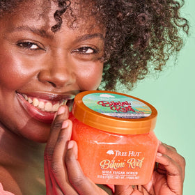 Tree Hut Bikini Reef Body Scrub 18 Oz displayed with tropical flowers