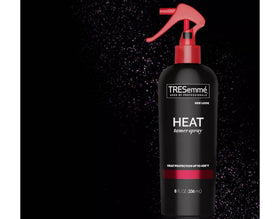TRESemmé Heat Tamer Spray in a bathroom setting
