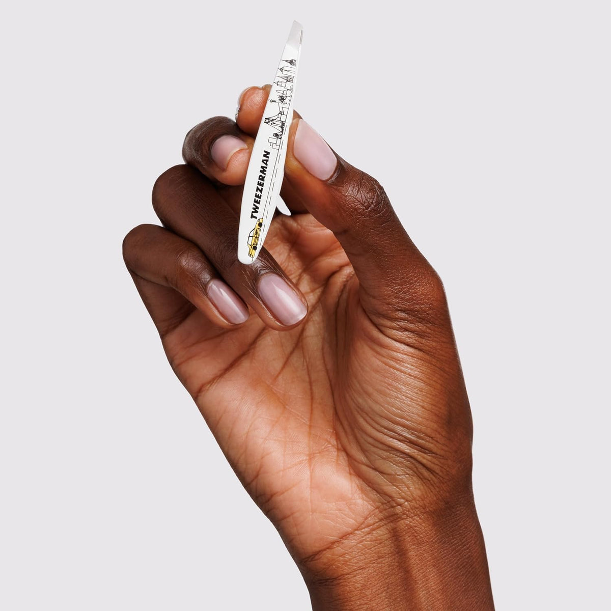Tweezerman Mini Slant Tweezer in hand demonstrating grip