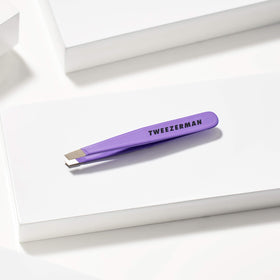Tweezerman Mini Slant Tweezer in hand for usage