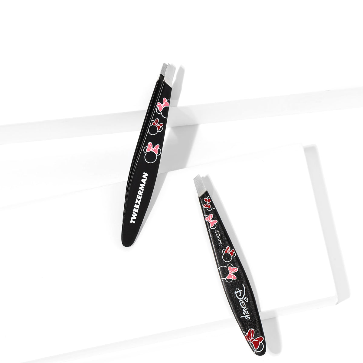 Tweezerman Minnie Mouse Mini Slant Tweezer with a hand for scale