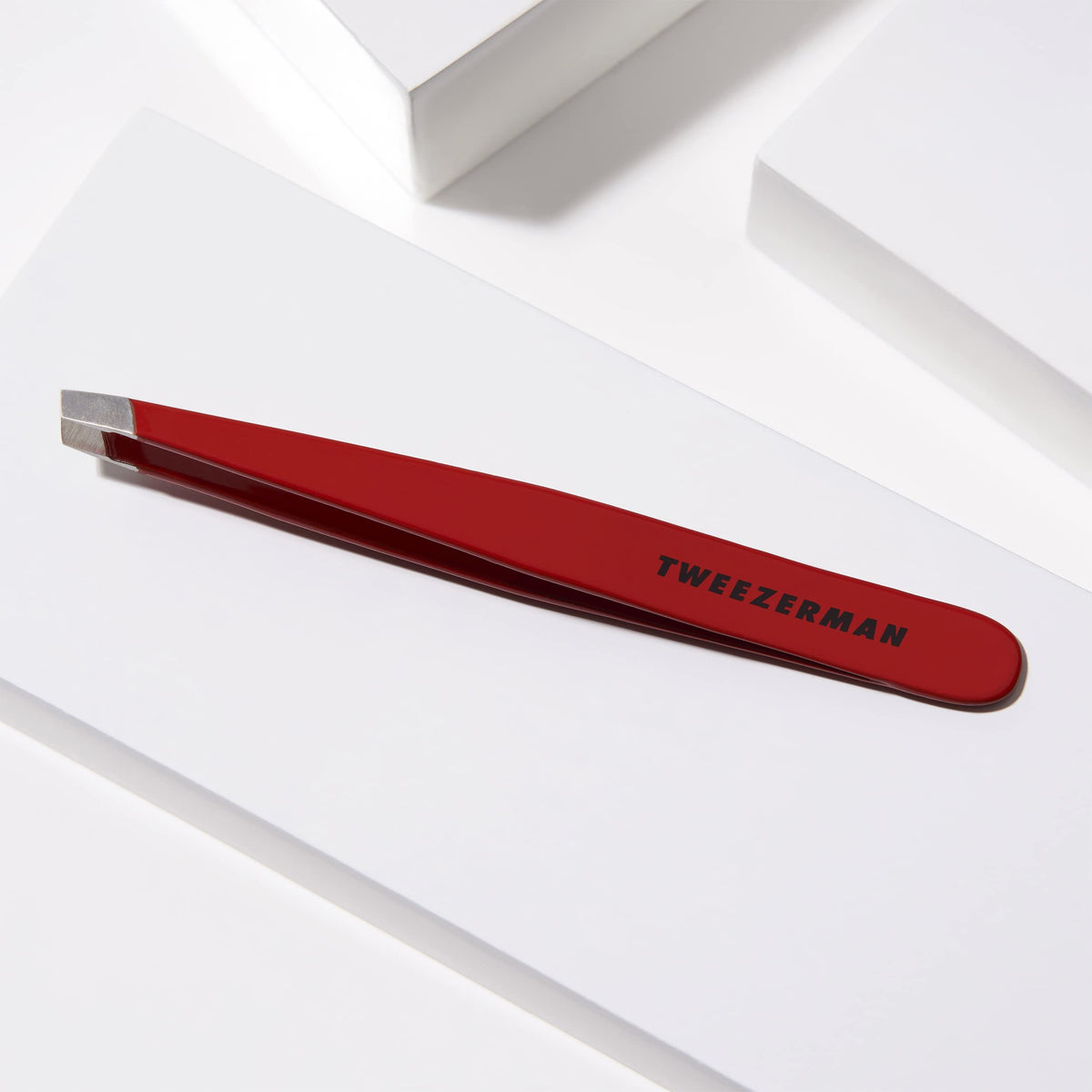 Tweezerman Slant Tweezer in hand demonstrating use