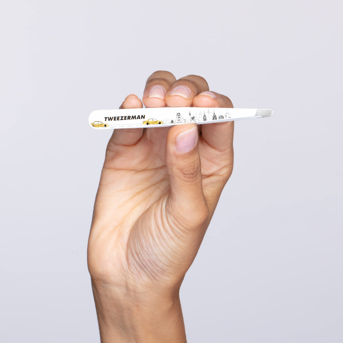 Tweezerman Slant Tweezer on a bathroom counter