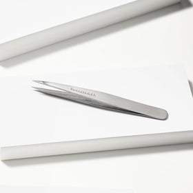 Tweezerman Steel Point Tweezer in hand for demonstration