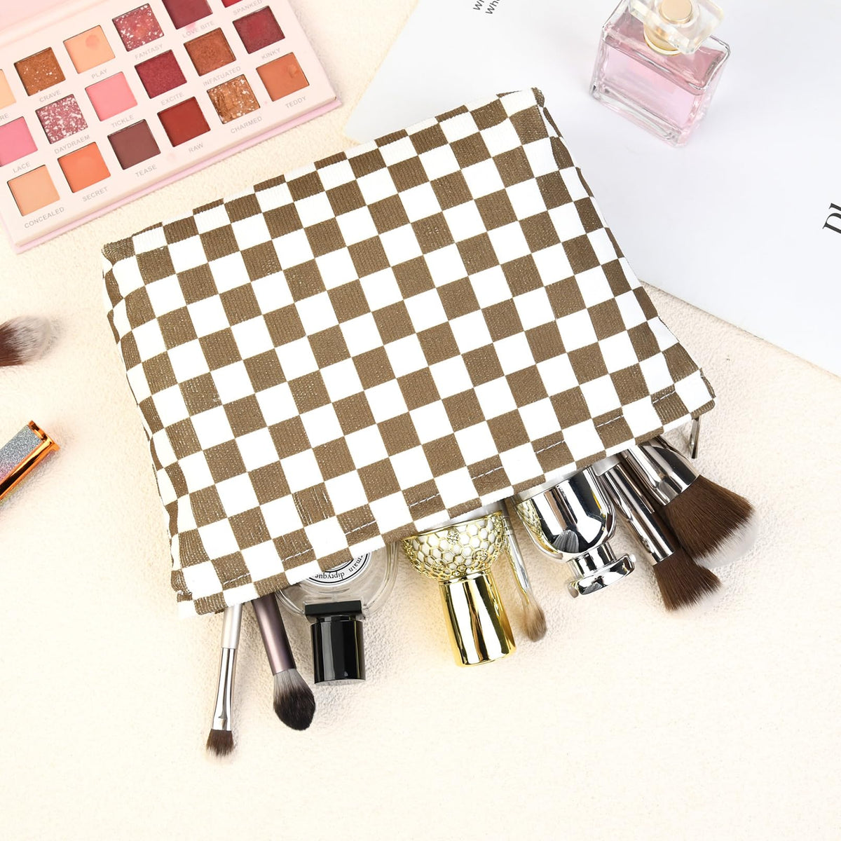 Two SOIDRAM makeup bags with beauty products arranged