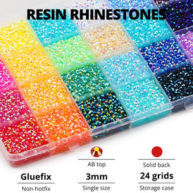 User applying rhinestones with wax tip gem picker and glue