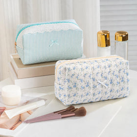 UUYUUY floral cosmetic pouch displayed on a vanity