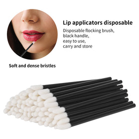 Vaincre Disposable Lip Wands displayed in a makeup bag
